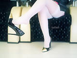 Teen wearing secretary high heels and white stockings.
